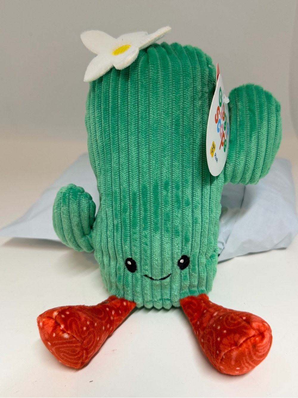 Green Cactus Plush Toy with Red Feet and White Flower